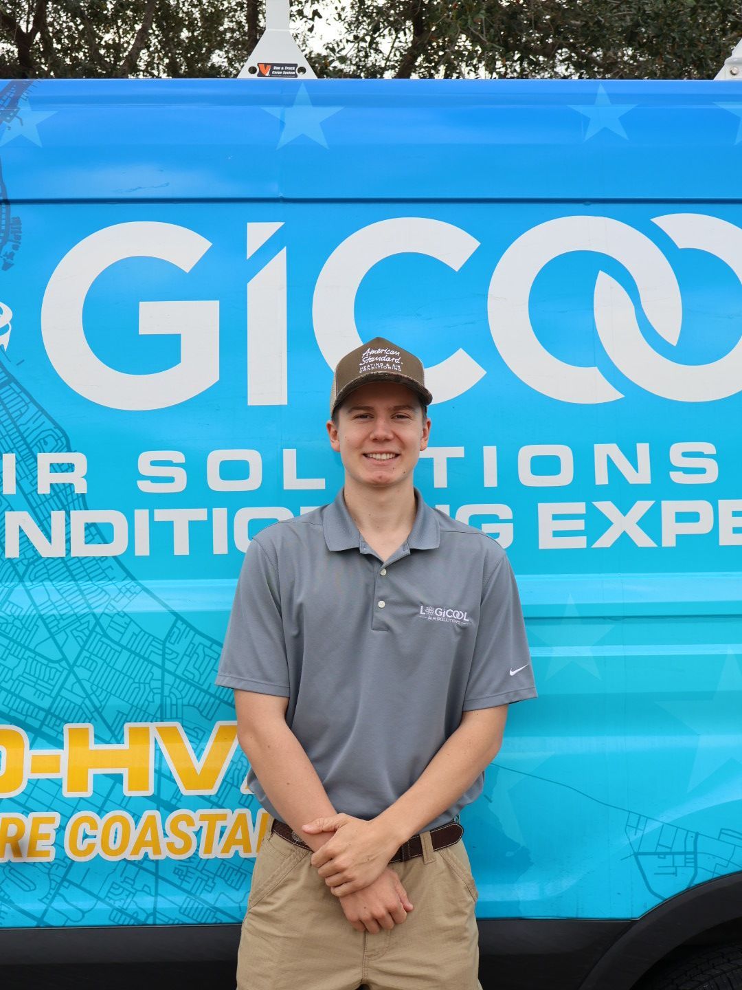 Smiling person in gray shirt standing before a blue GICCO air solutions truck wrap.