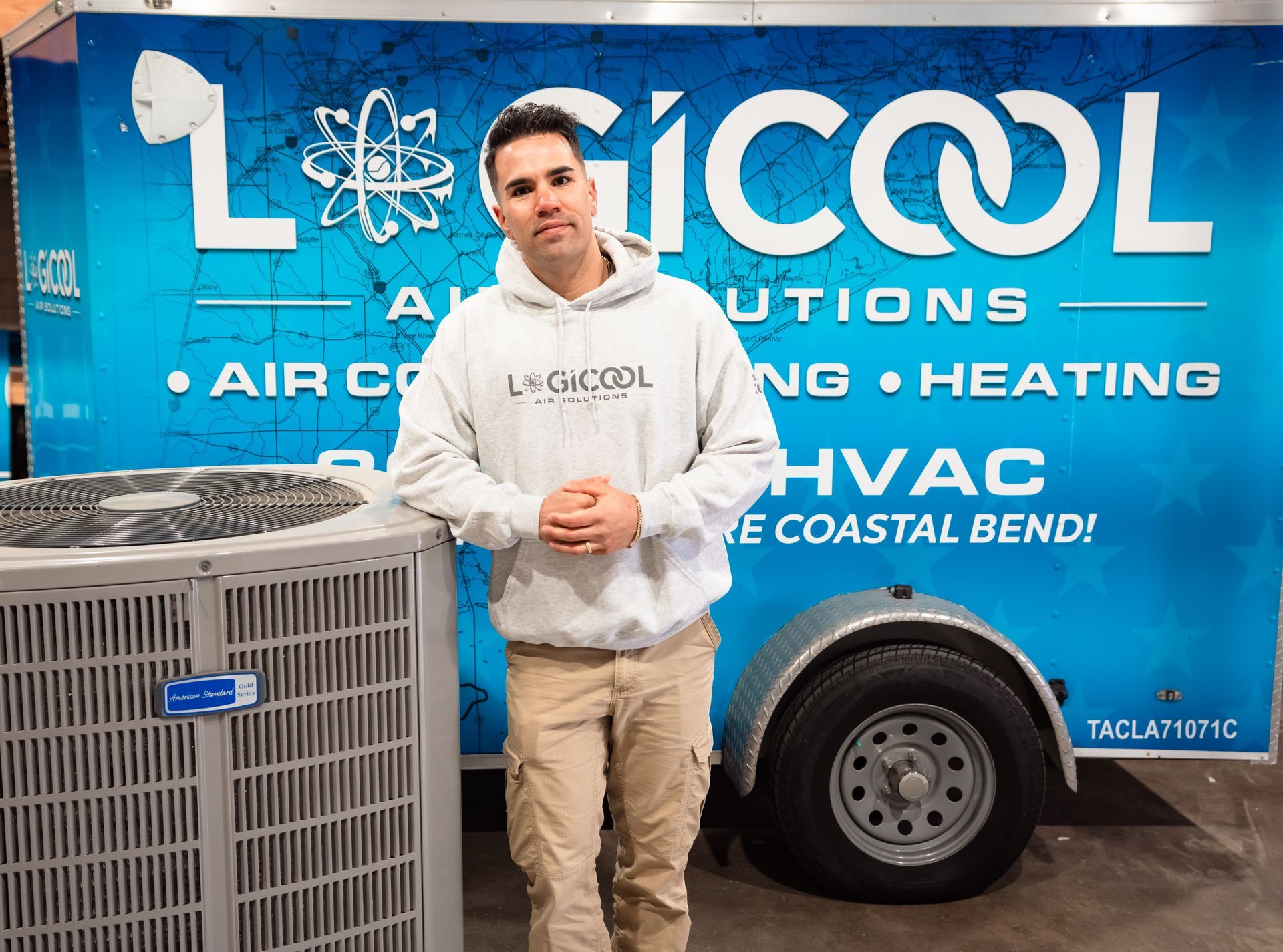 Man standing beside a Limco HVAC service van with blue signage and a visible air conditioner unit.