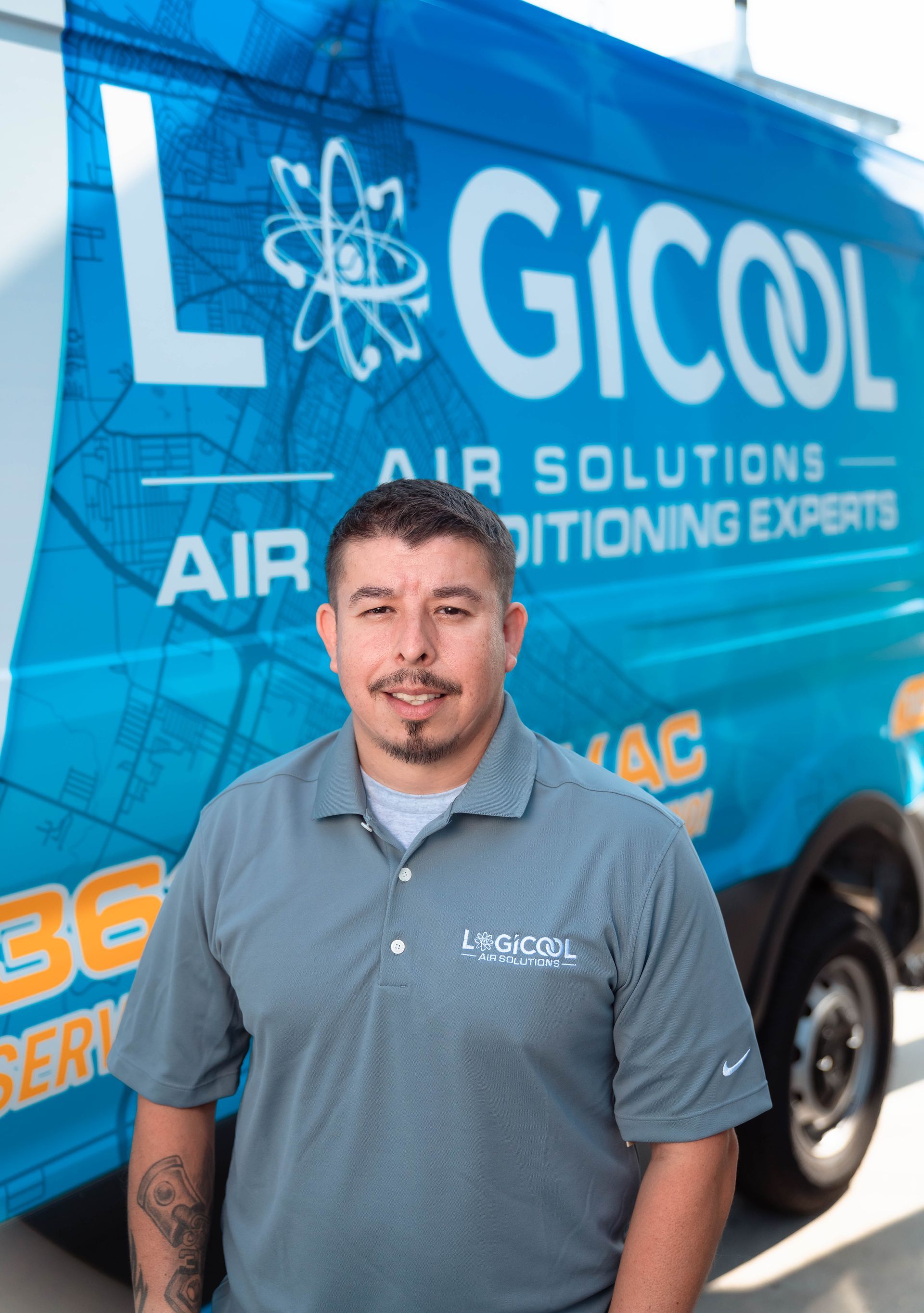 Man standing beside a blue Logistics air solutions van with company branding