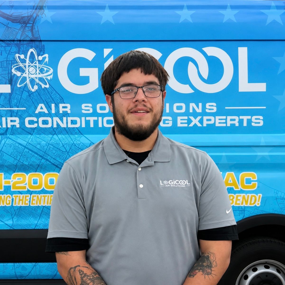 Woman in gray polo standing in front of a blue Logicool HVAC service van and smiling