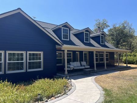 Navy siding and cream trim on a freshly painted home in Central Point, Oregon.