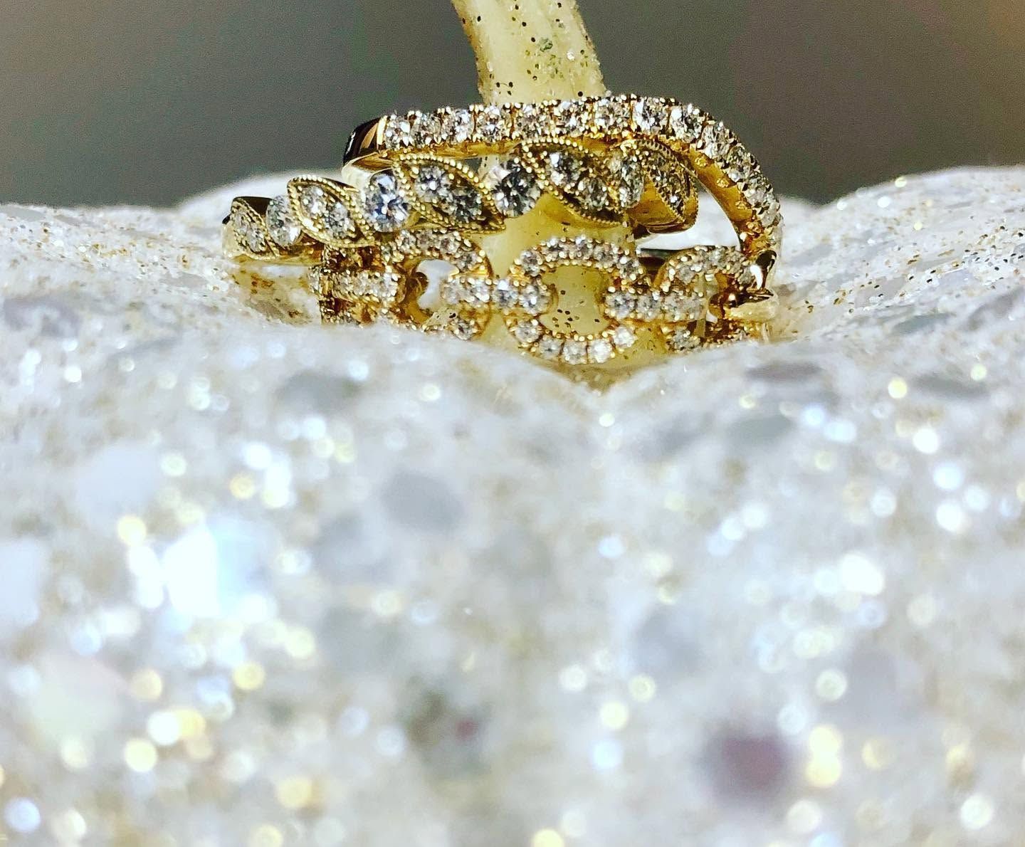 Gold ring on a sparkling white surface, close-up detail
