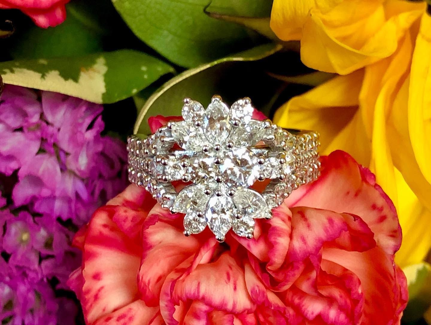 Diamond ring on colorful flower petals and blooms