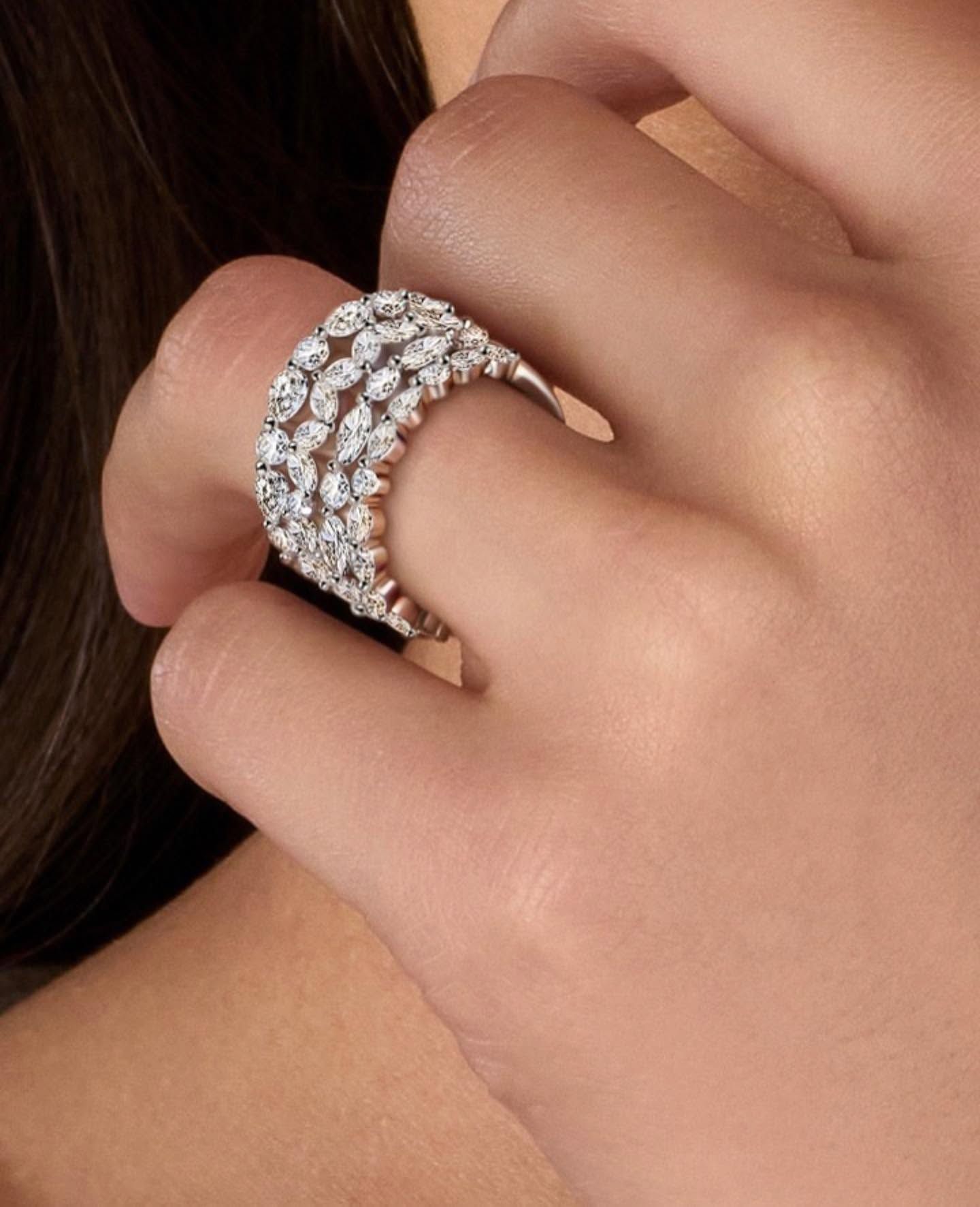 Hand wearing a sparkling diamond ring on a finger, close-up