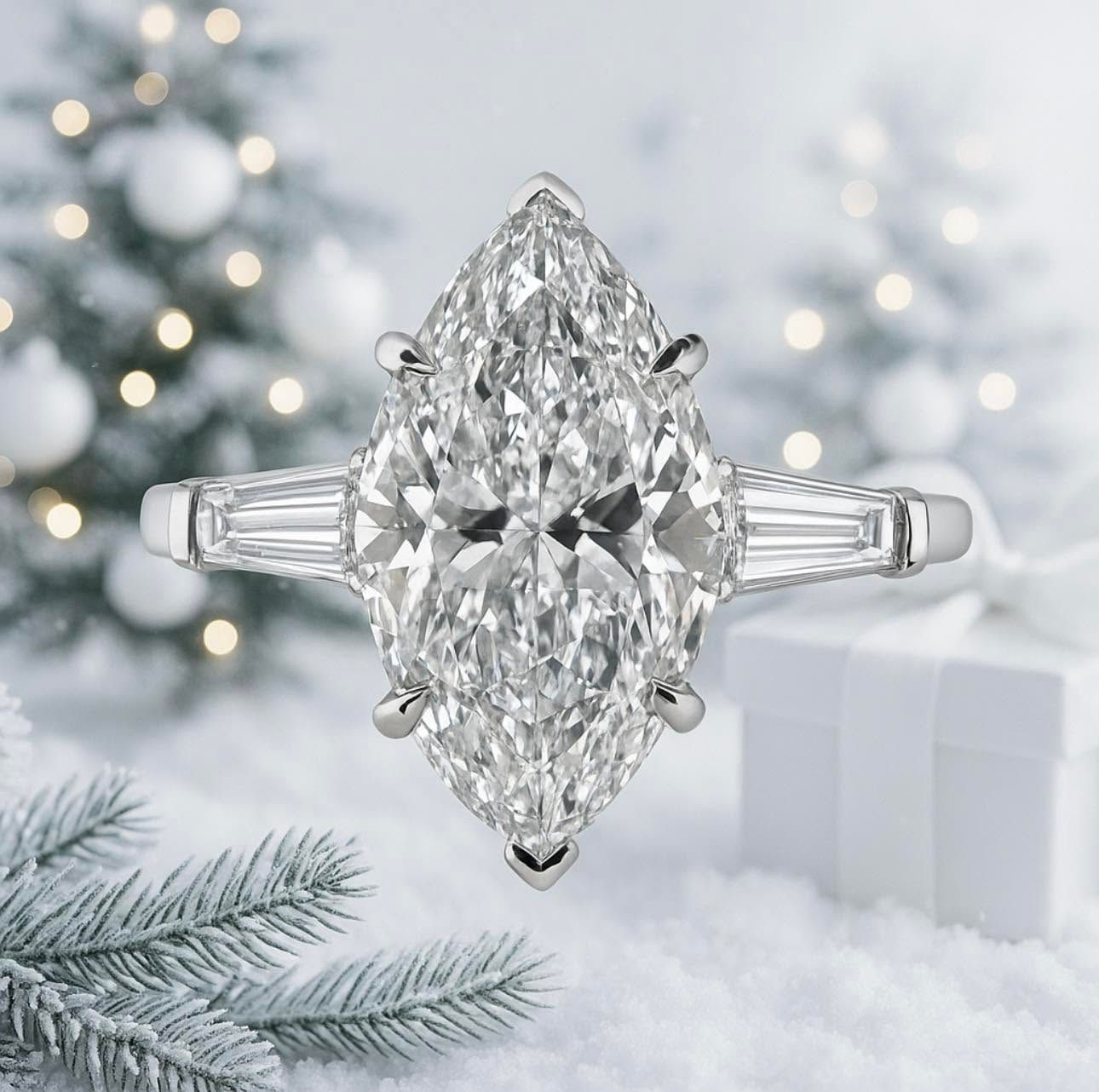 Marquise-cut diamond ring on a white snowy holiday backdrop with blurred Christmas lights and gift boxes