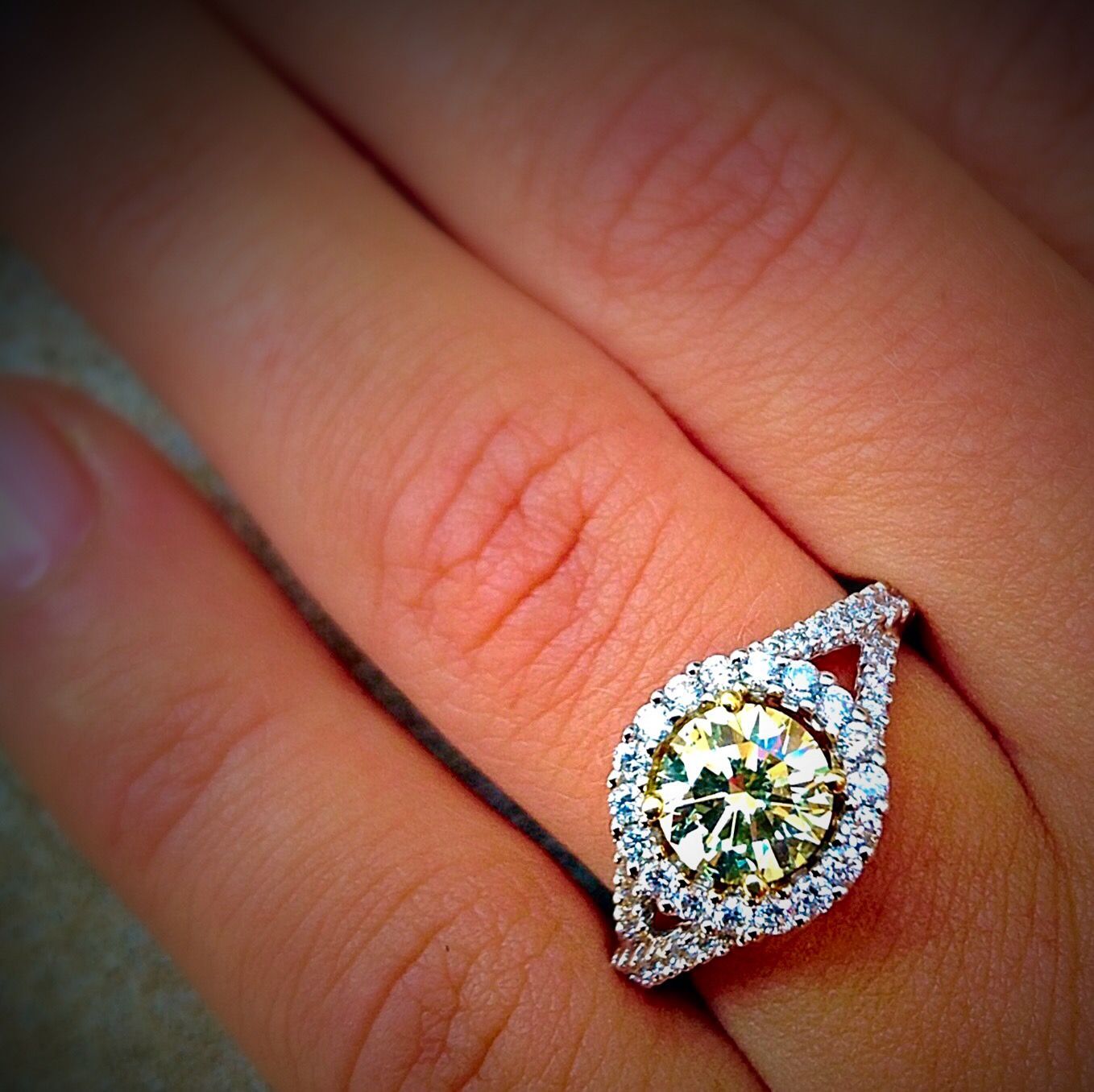 A woman wearing a diamond ring on her left hand