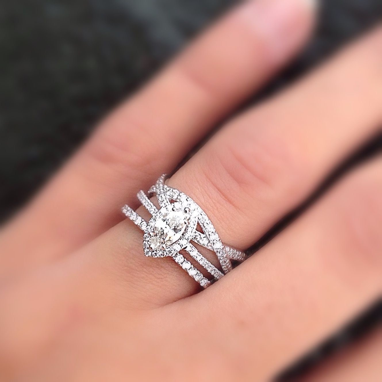 A woman wearing a wedding ring and engagement ring on her finger