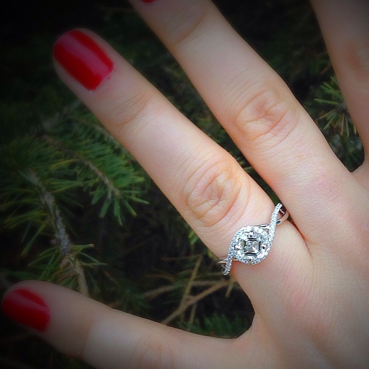 A woman wearing a diamond ring on her left hand