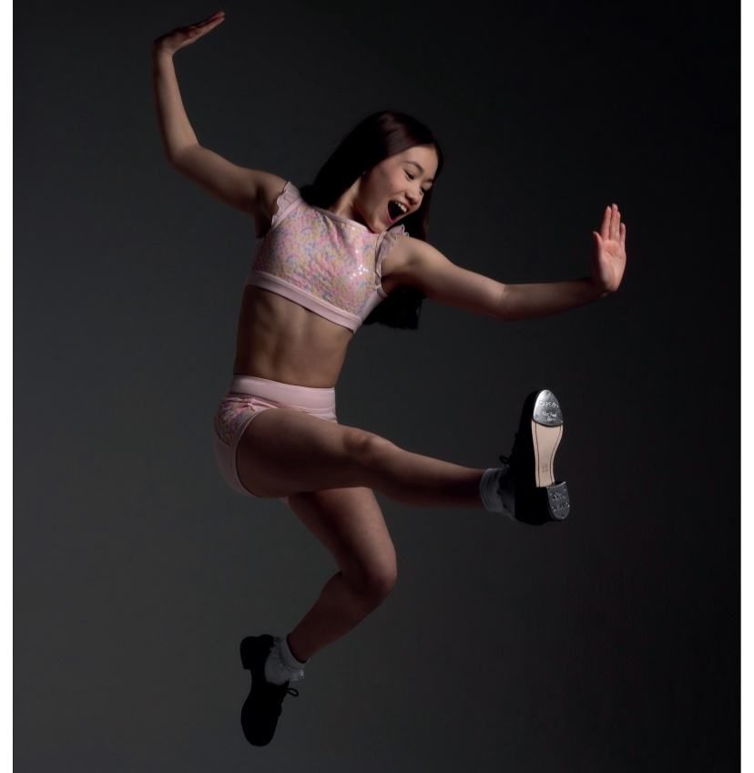A Woman In A Pink Top And Shorts Is Jumping In The Air — Dance Jam In Burnside, QLD