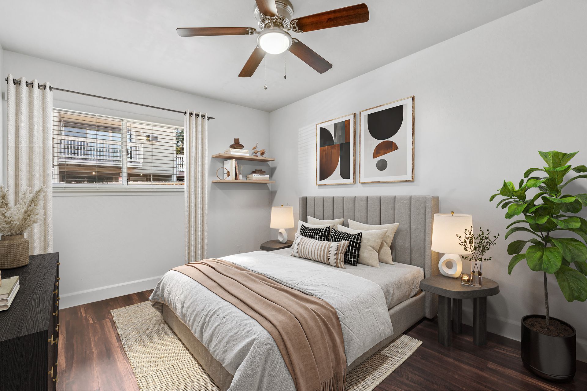 Cozy modern bedroom with a bed, ceiling fan, window blinds, and neutral decor.