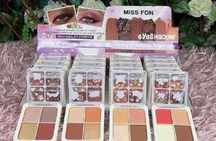 Exhibición de maquillaje: Paletas de sombras de ojos Miss Fon, varios colores, entorno minorista.