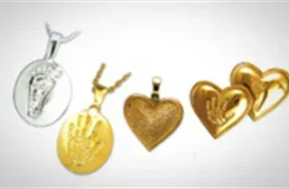 Assorted gold and silver heart-shaped pendants and charms on a white background