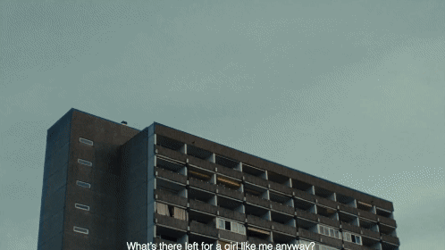 Hochhaus mit zerbrochenen Fenstern unter bewölktem Himmel.