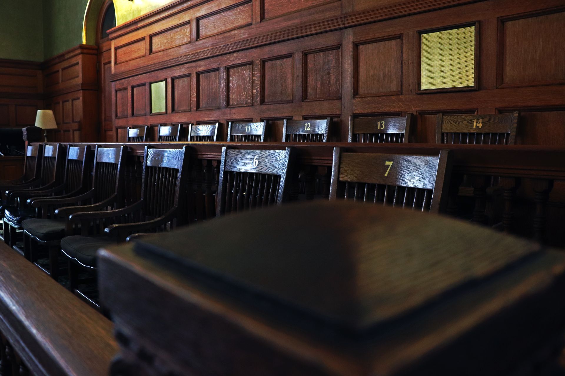 a row of wooden chairs with the numbers on them
