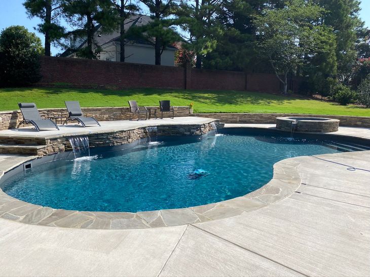 a large swimming pool with a waterfall in the middle