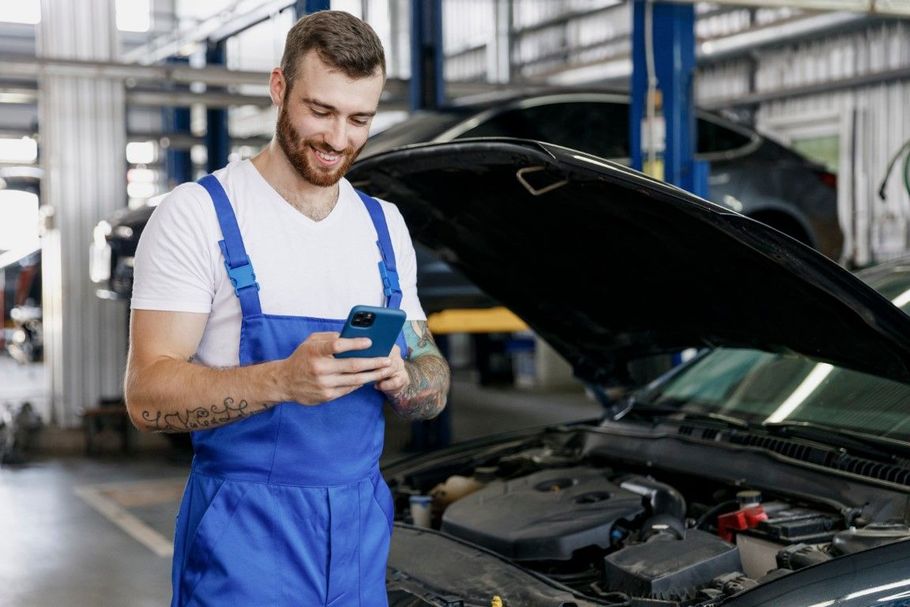 Mechanic using a wrench to repair a car engine.