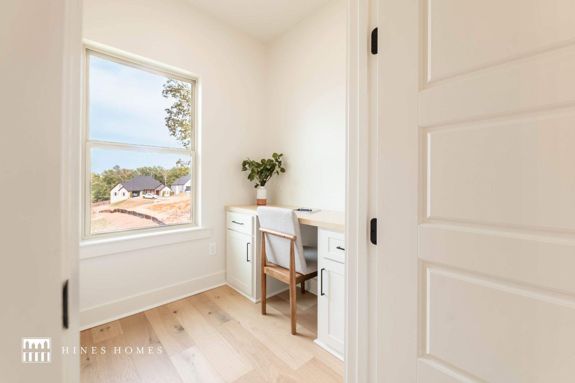 small space maximized for an office with a big window for natural light in a home built by hines homes