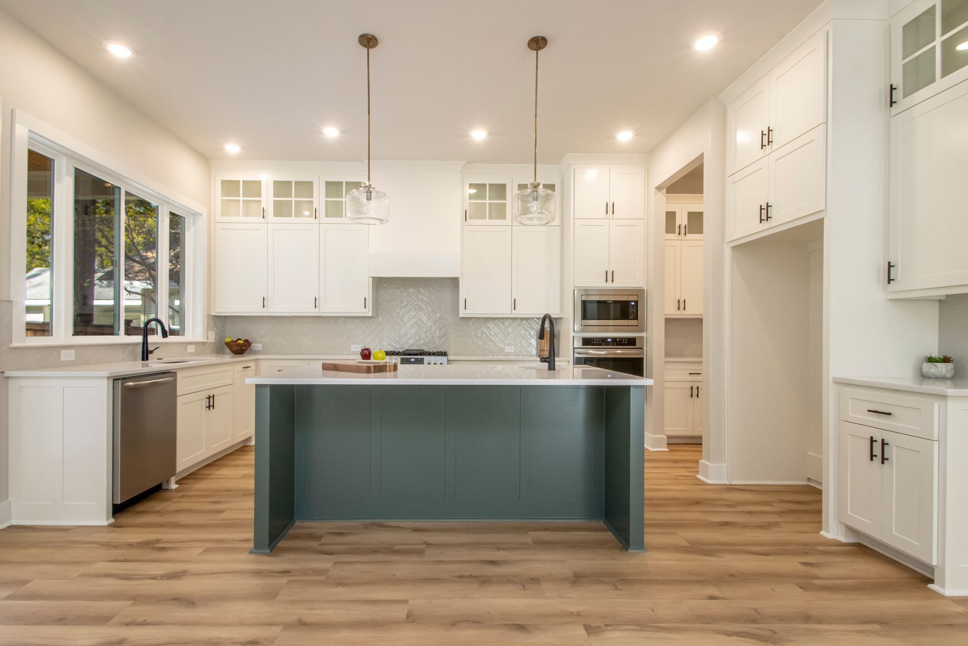 inviting kitchen with a big island for seating and white cabinets