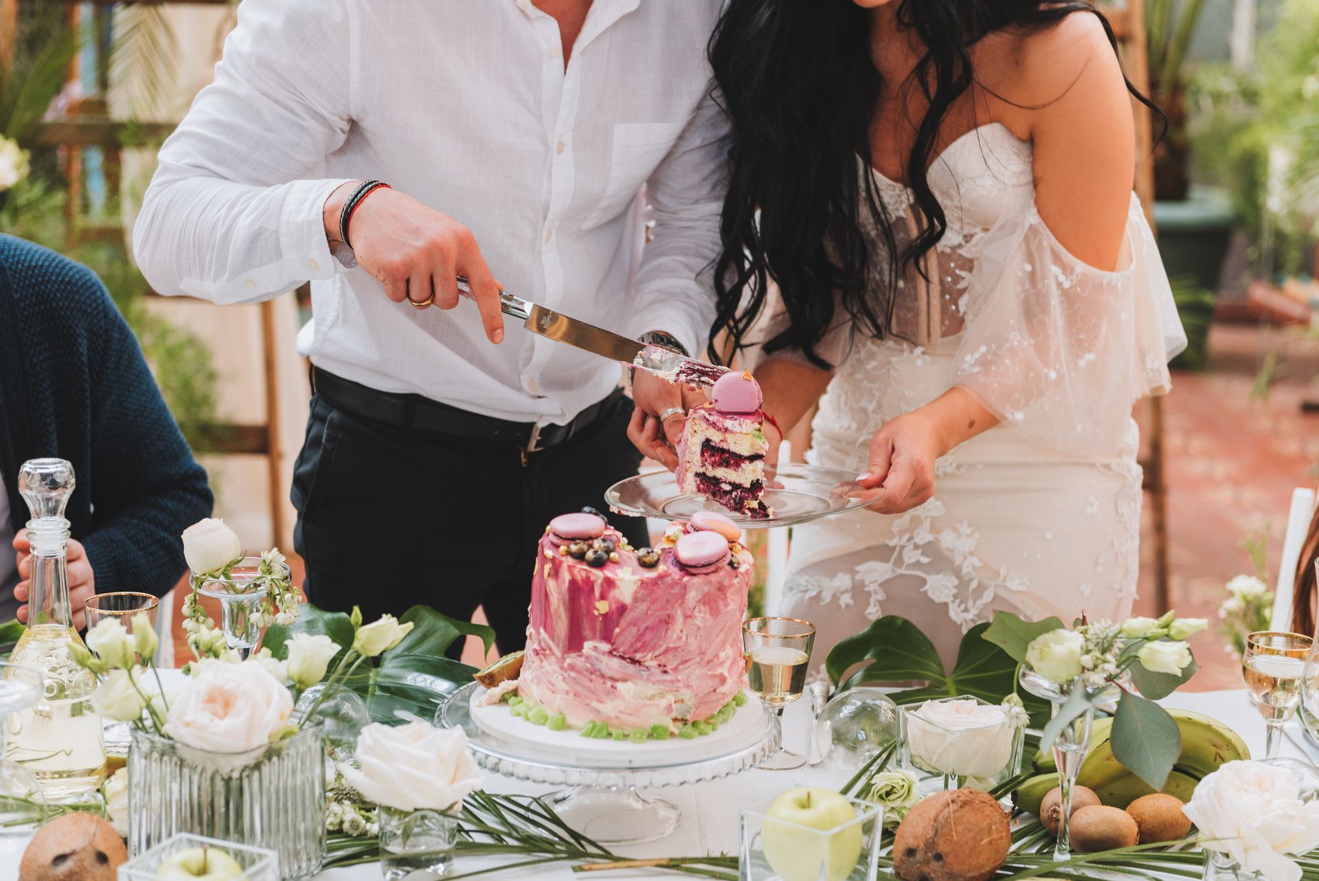 bride and groom cutting a small modern wedding cake on a table