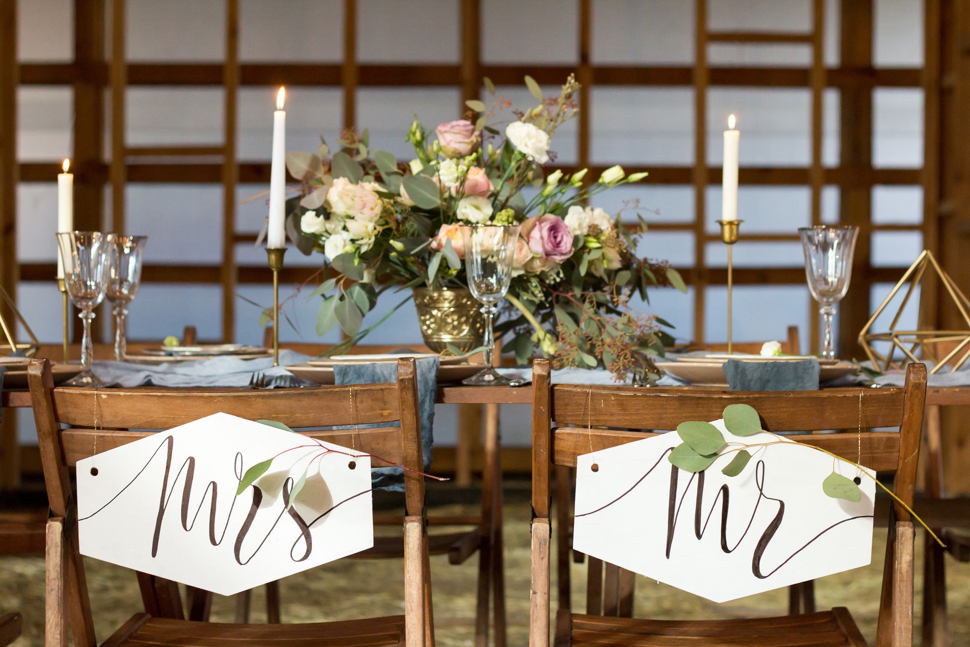 Bride and Groom seating in barn wedding venue.