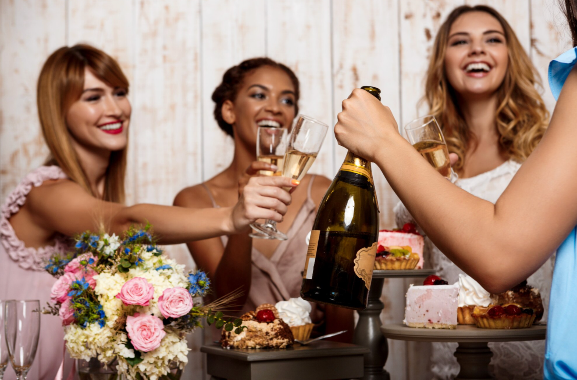 Female wedding guests sharing champagne during the reception.