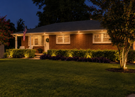 Covered porch with rocking chairs, patterned rug, ceiling fan, and views of trees and neighboring houses.