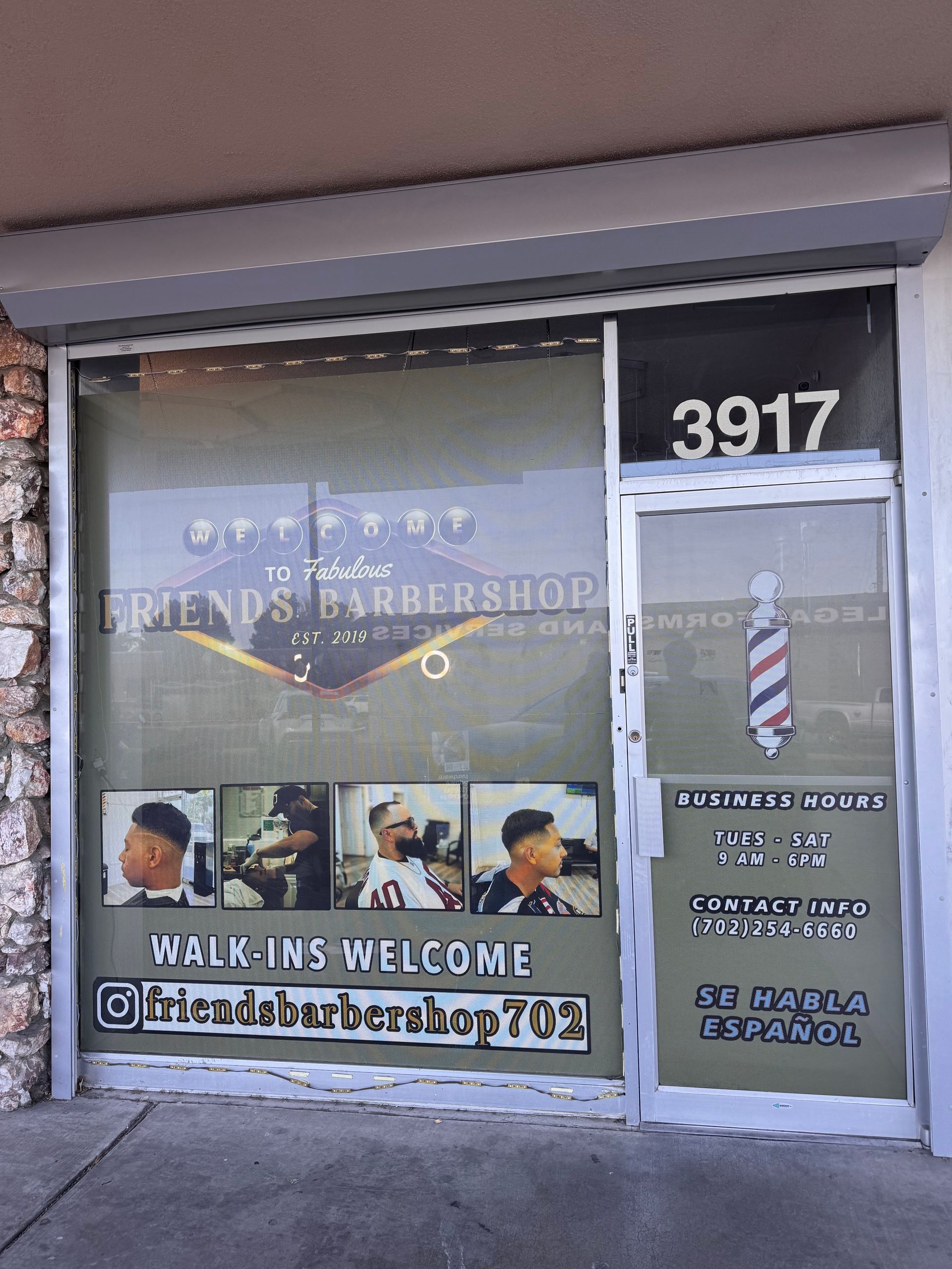 Storefront with barber shop sign, door number 3917, and photos of hairstyles in the window