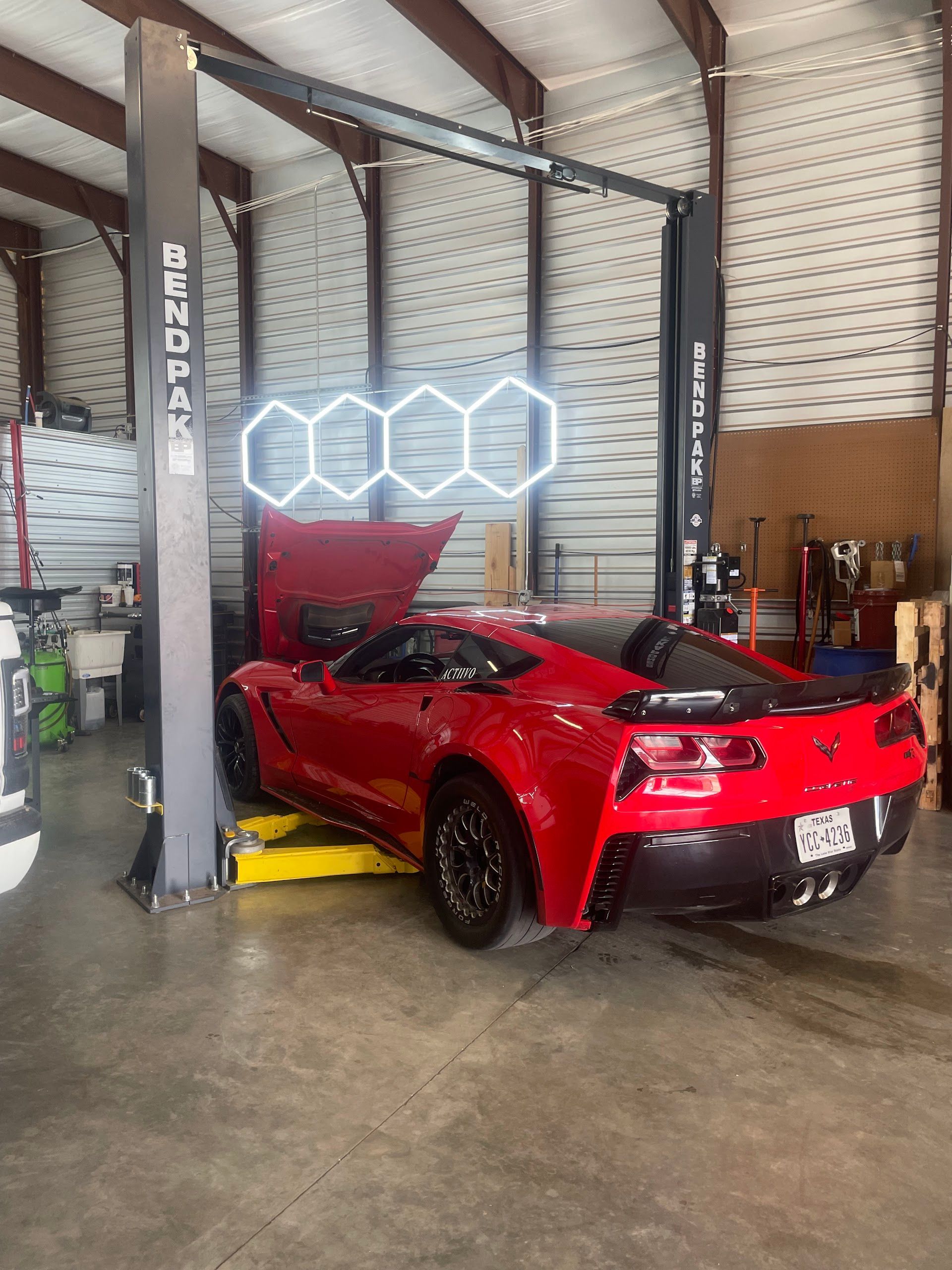 Red Sports Car On An Automotive Lift Inside The Shop | TLC Automotive