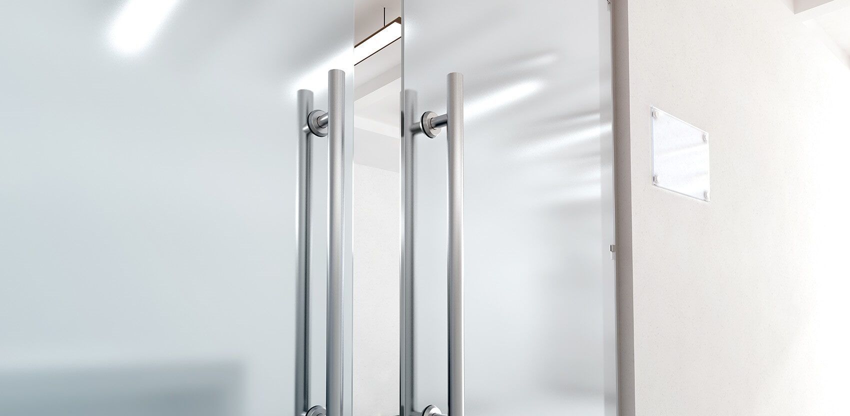 A Close Up of a Glass Door With Stainless Steel Handles — Darwin Glass in Yarrawonga, NT