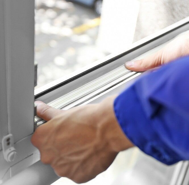 A Person in a Blue Jacket is Opening a Window — Darwin Glass in Yarrawonga, NT