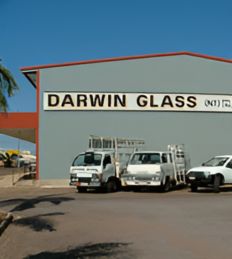 Cars Parked in Front of a Building That Says Darwin Glass — Darwin Glass in Yarrawonga, NT