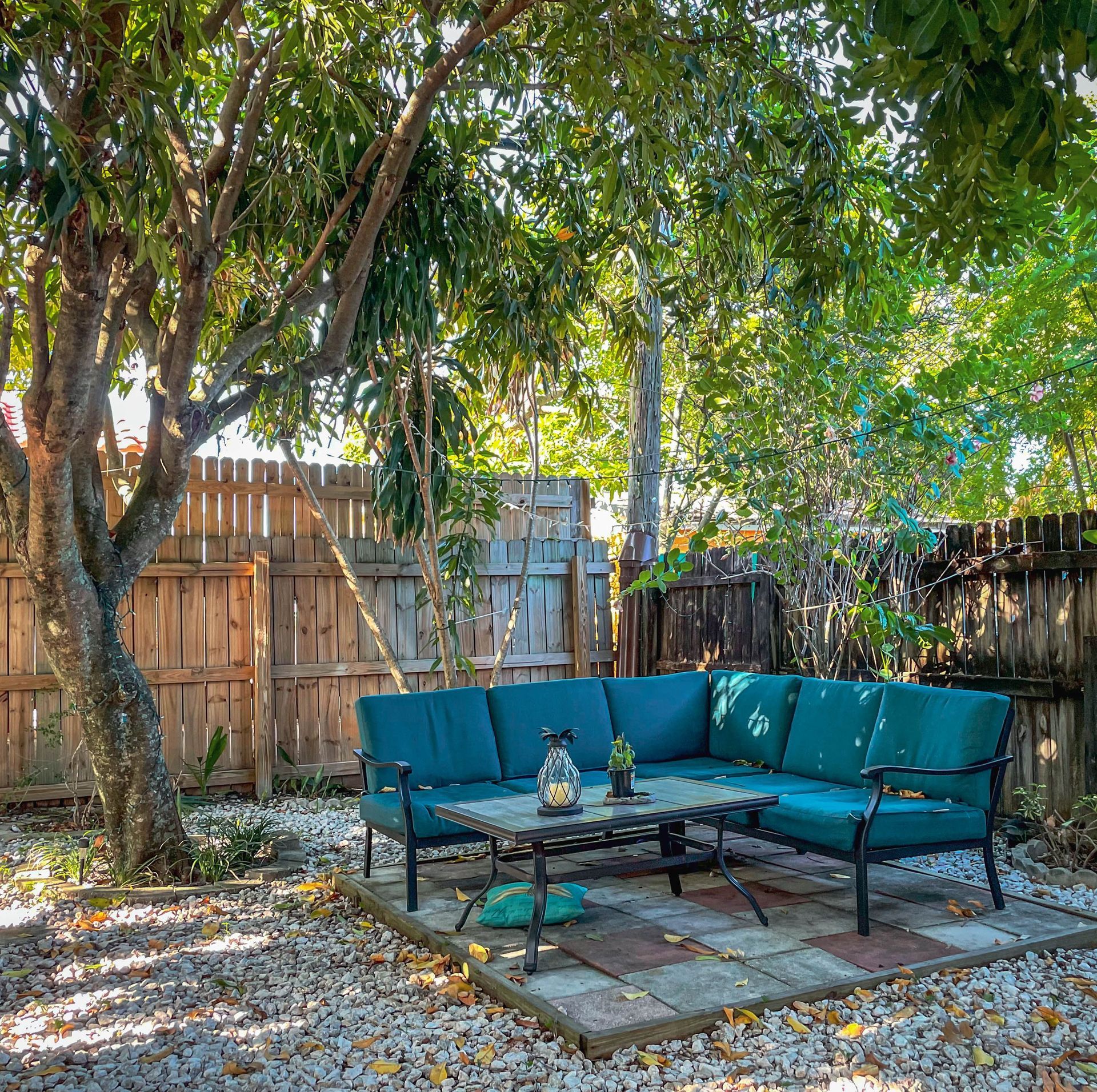 Garden seating area on a patio beside a timber fence