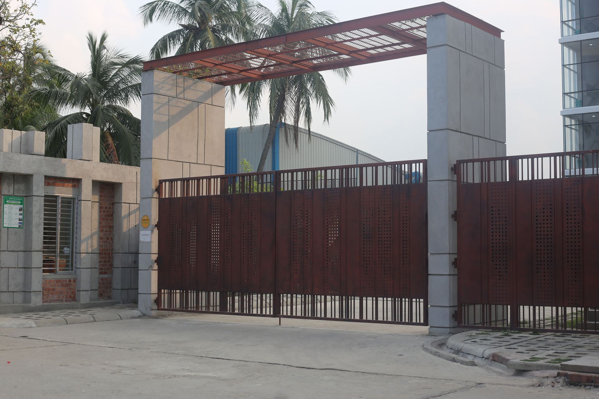 Wide slatted sliding gate across the entrance to a modern property