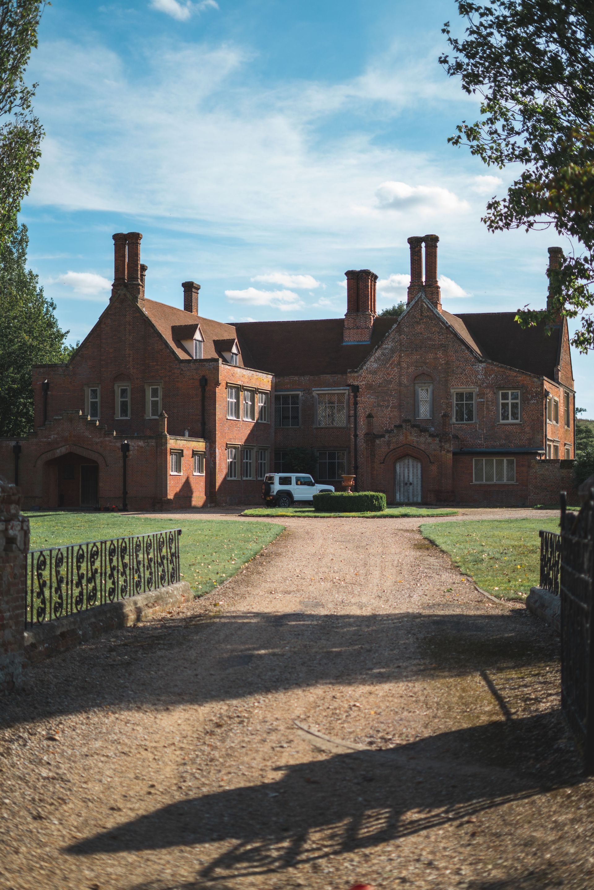 Period brick house at the end of a long driveway