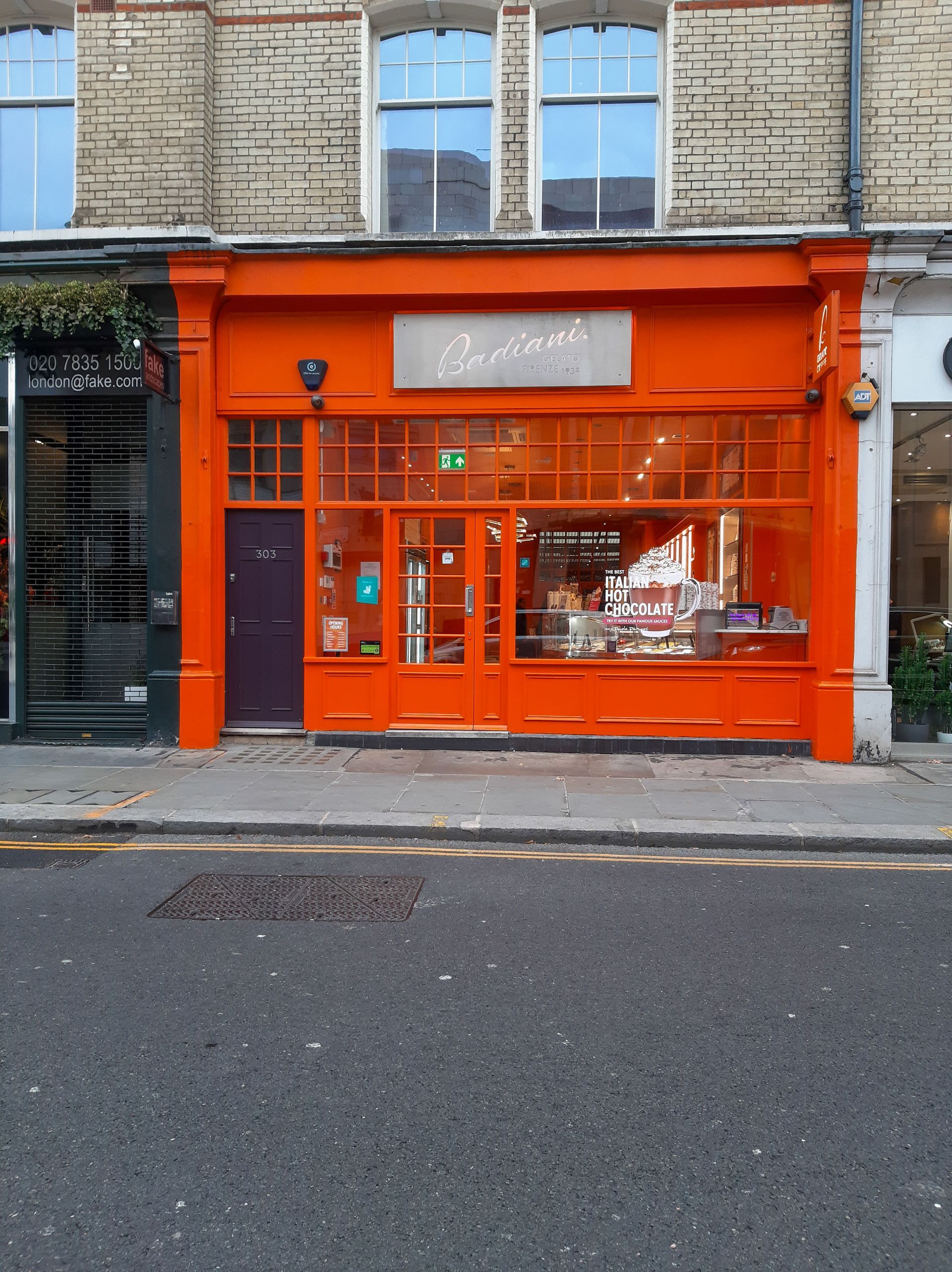 Shop front painted bright orange on a high street