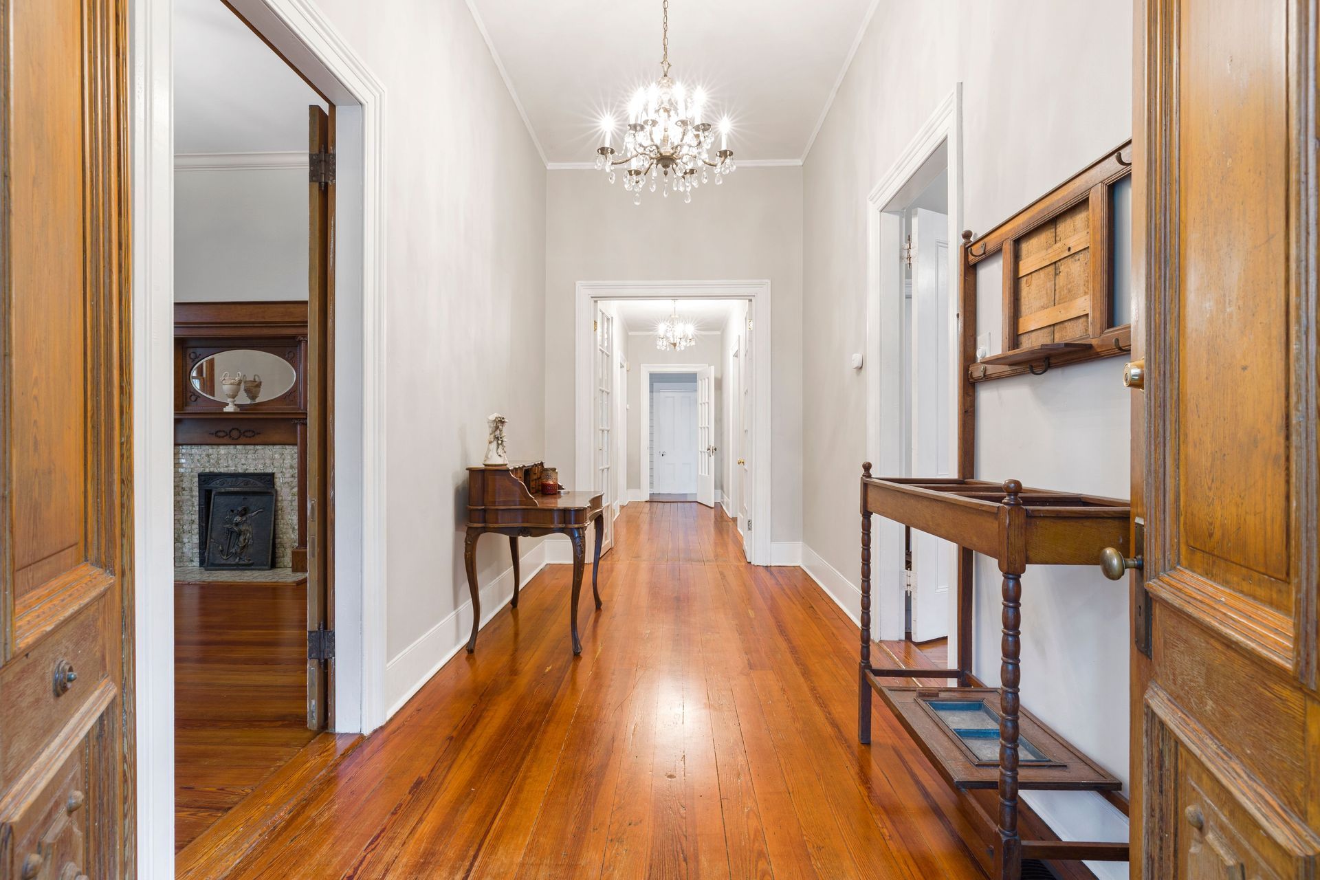 Narrow hallway with a warm wooden floor