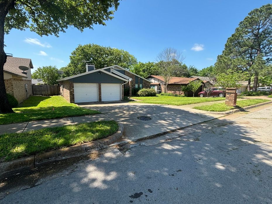 A house with two garage doors in a residential neighborhood
