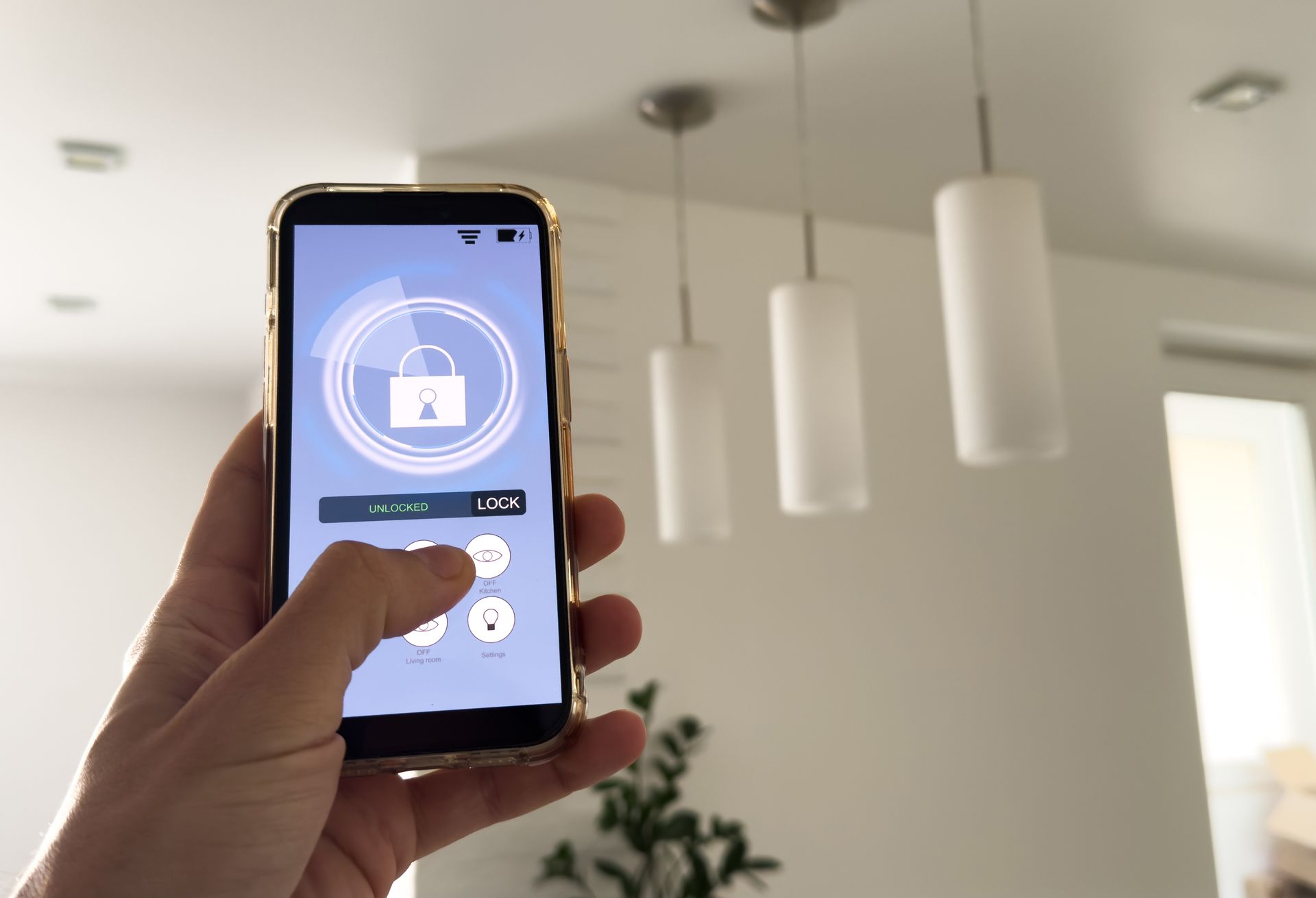 Hand holding smartphone showing a lock icon on the screen in a bright indoor room