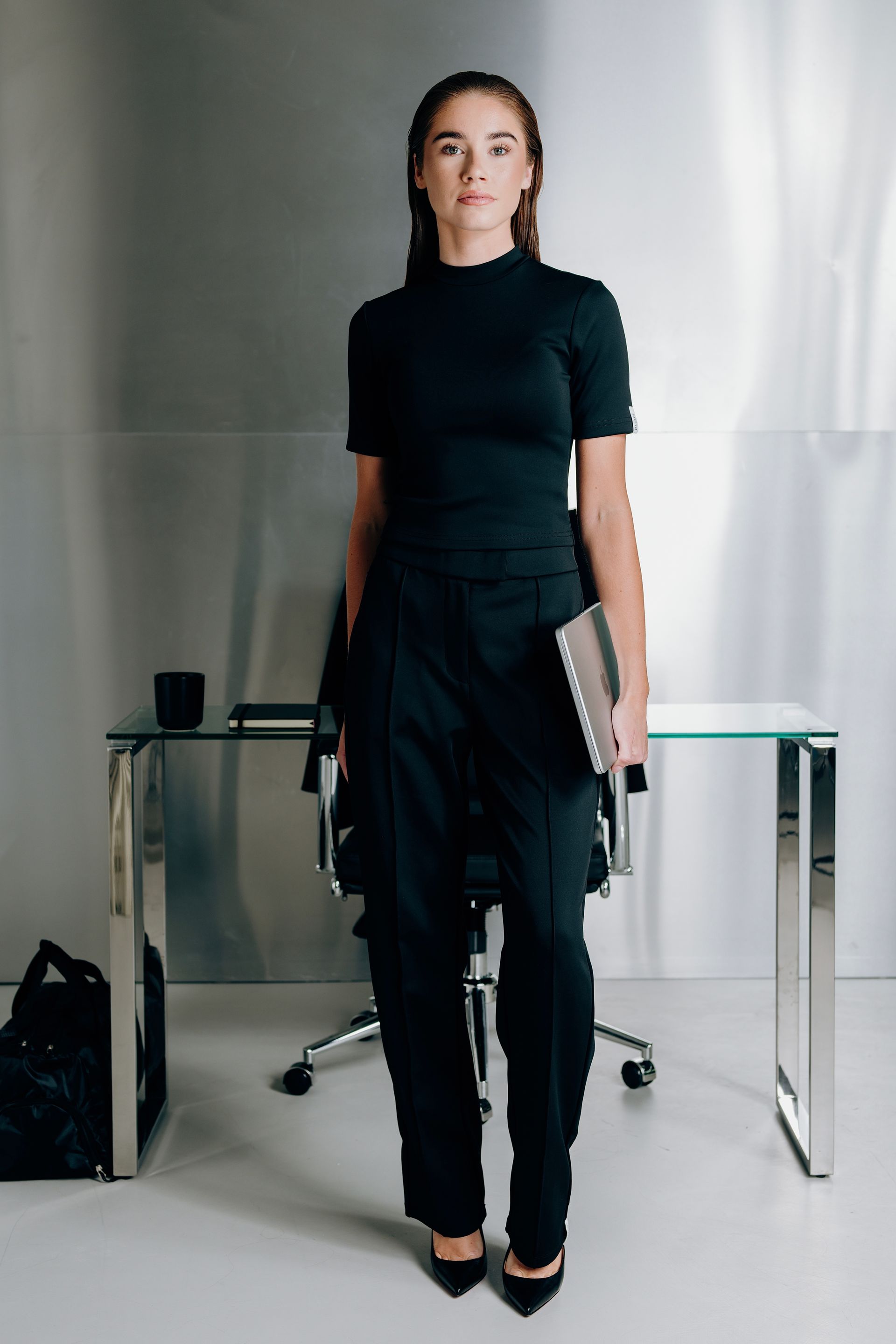 LINA SANTO campaign — professional woman in Interval Collection standing in front of the desk