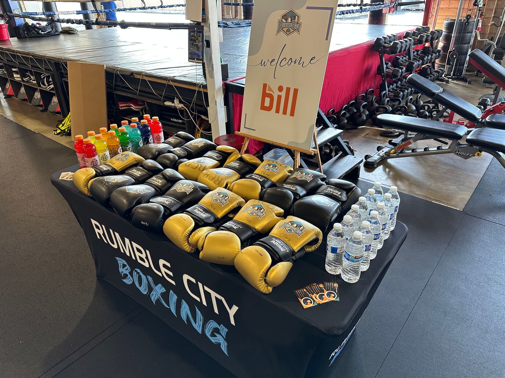 Boxing gloves and drinks displayed on a table at Rumble City Boxing, welcoming Bill.