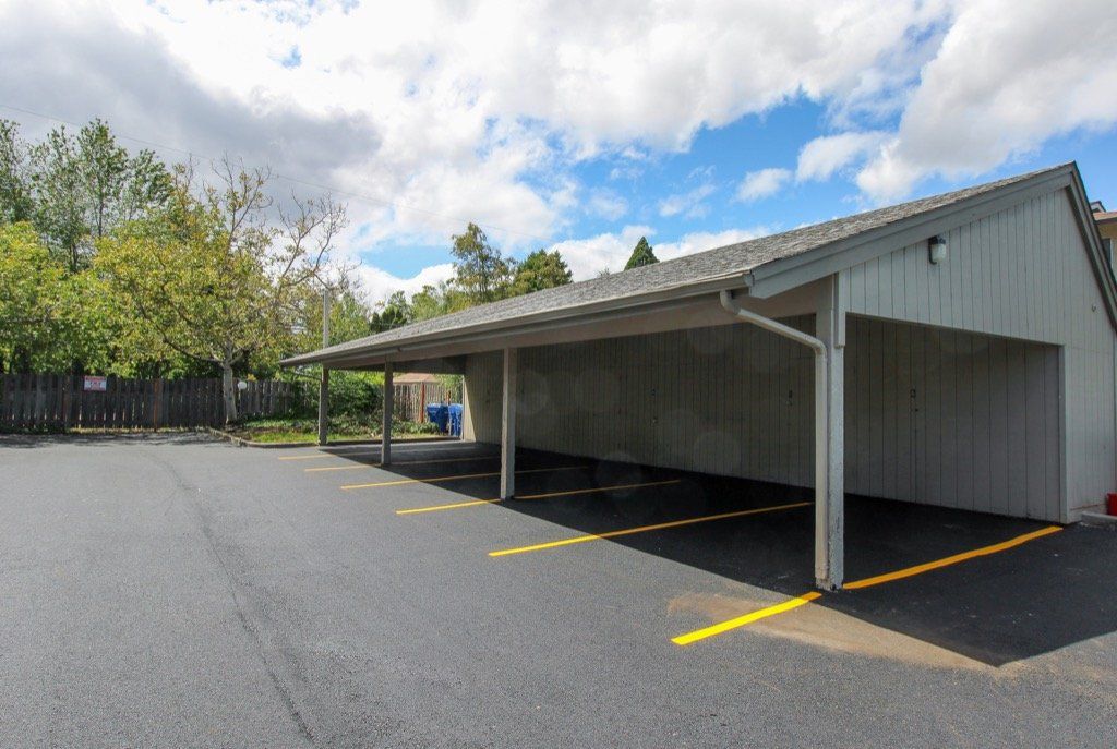 A parking lot with a carport in the middle of it.