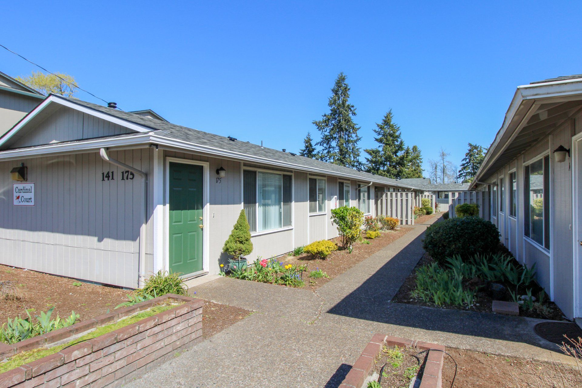 A row of apartment buildings with a walkway between them
