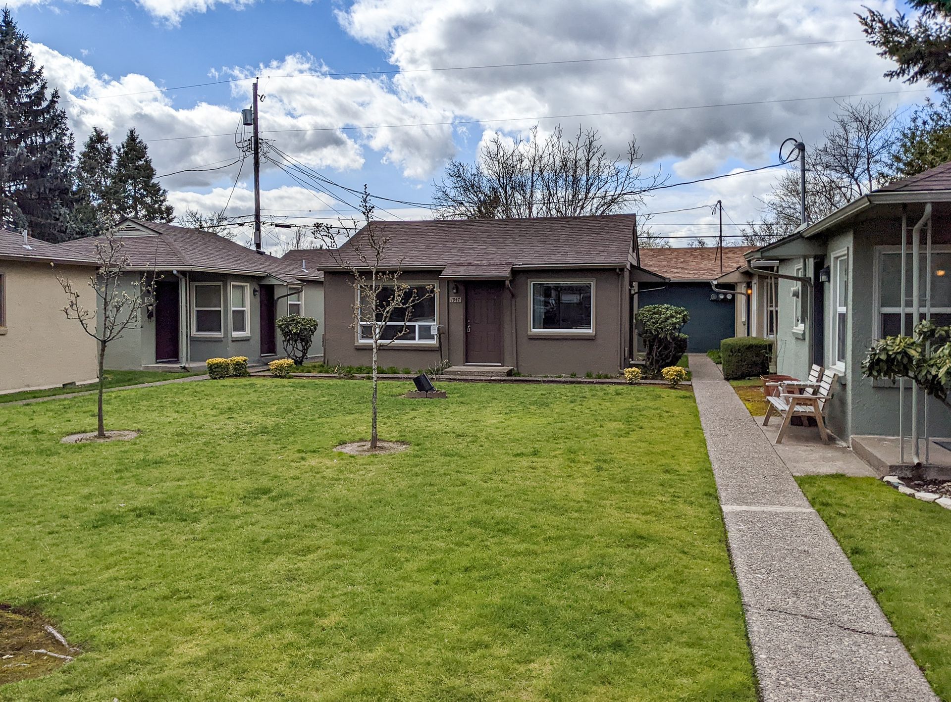 A row of houses are sitting next to each other on a lush green lawn.