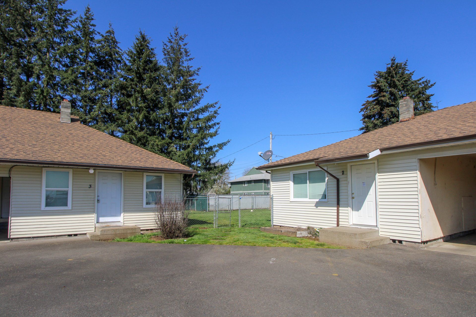Two houses are next to each other on a sunny day