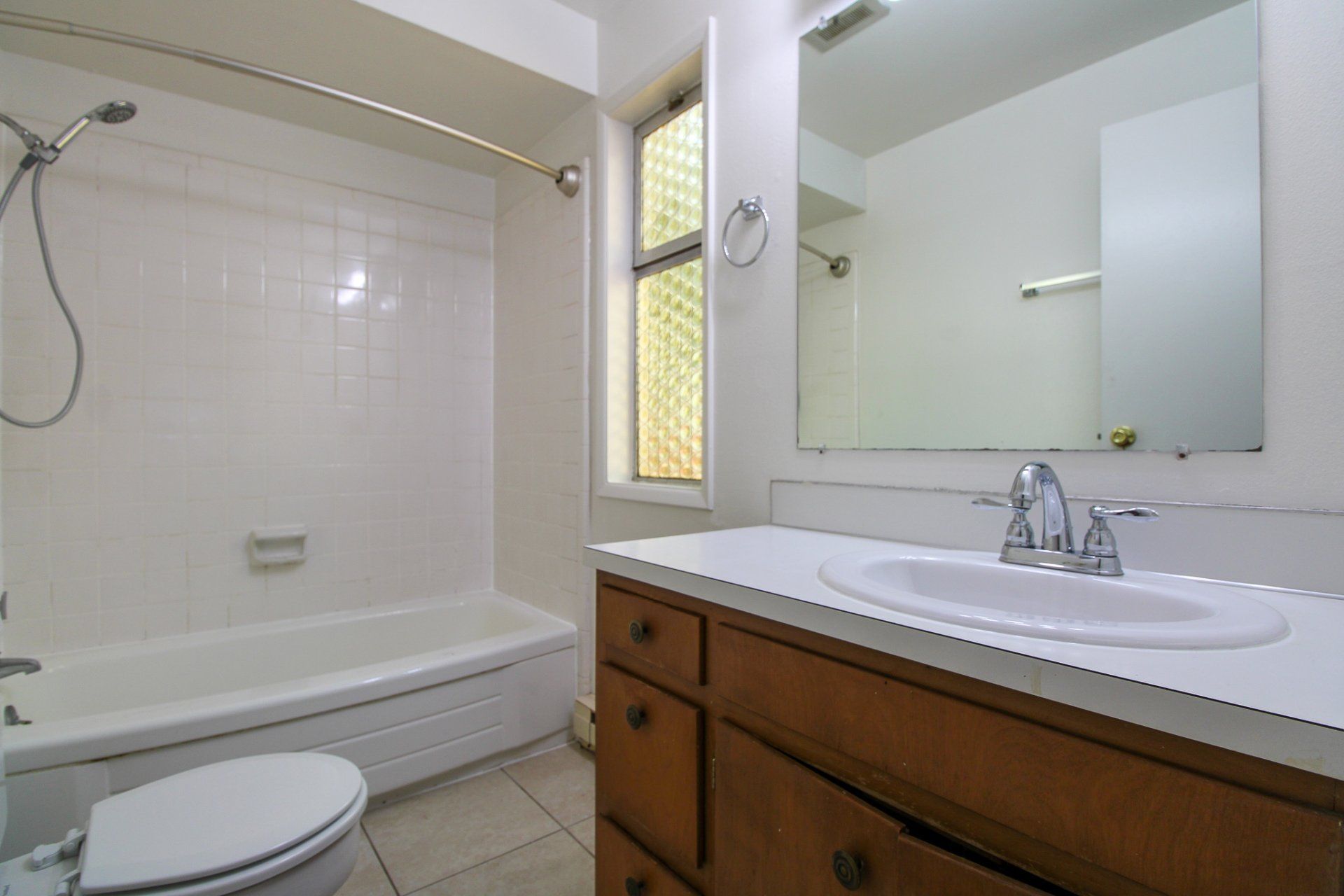 A bathroom with a toilet a sink and a bathtub