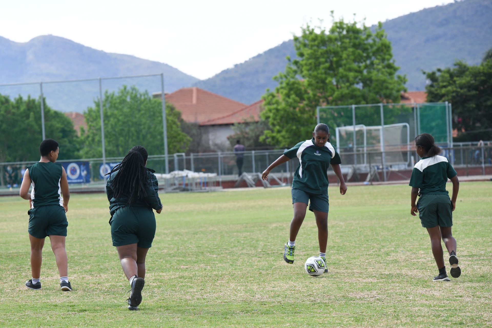 a group of students are playing soccer on a field .