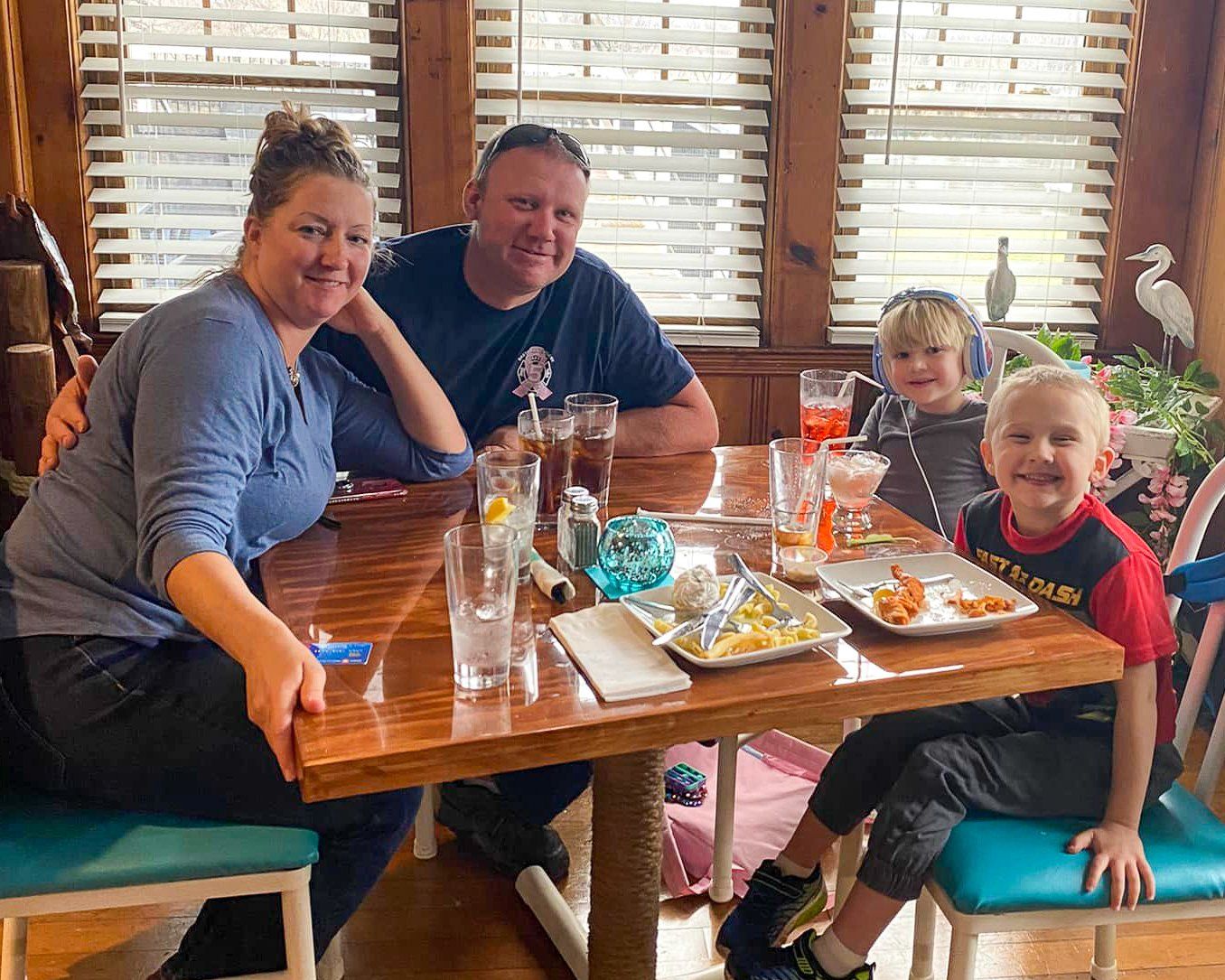 A family is sitting at a table in a restaurant.