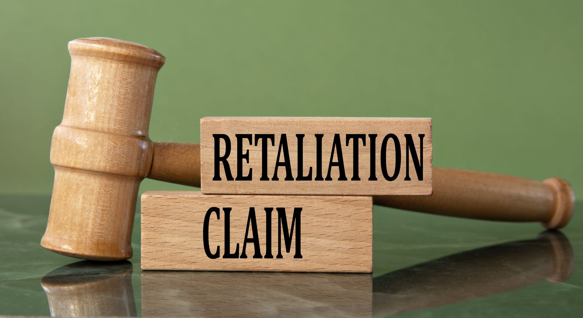 Wooden legal blocks reading retaliation claim next to a gavel for a retaliation claim attorney.