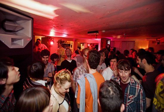 Crowded nightclub dance floor with people enjoying music and drinks