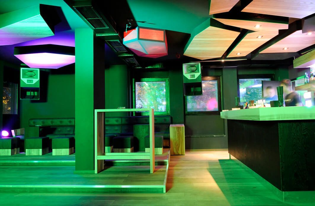 Modern nightclub bar with neon lighting and stylish seating design